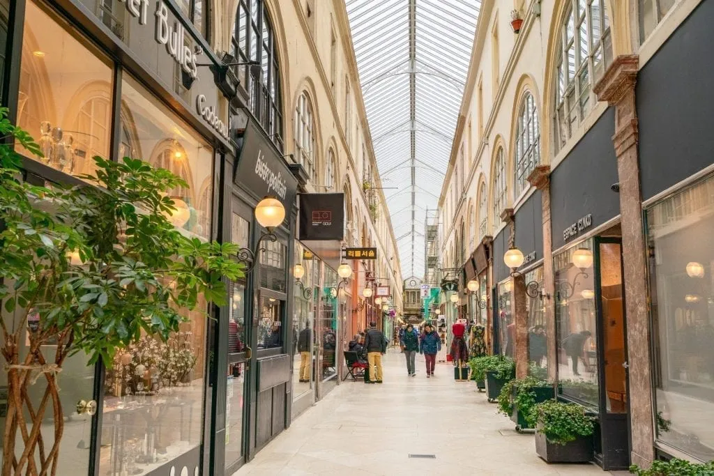 people shopping in paris in covered passageway