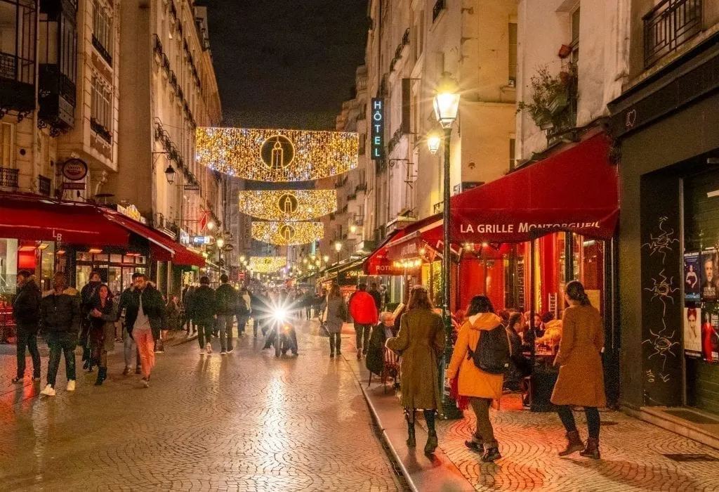 Rue Montorgueil with Christmas lights--a visit here definitely belongs on your list of what to do in Paris at night