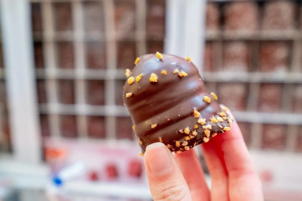Chocolate marshmellow being held up for the camera at the Strasbourg Christmas market