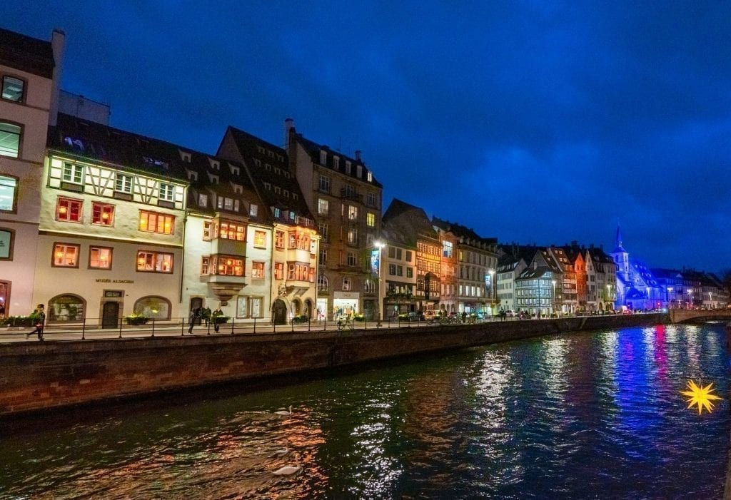 Strasbourg canal at blue hour with lights lit up on the buildings