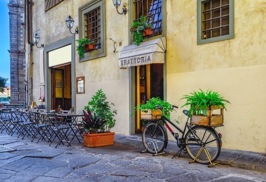 Exterior of a trattoria, a great casual place to explore food in Florence, with a bike parked outside