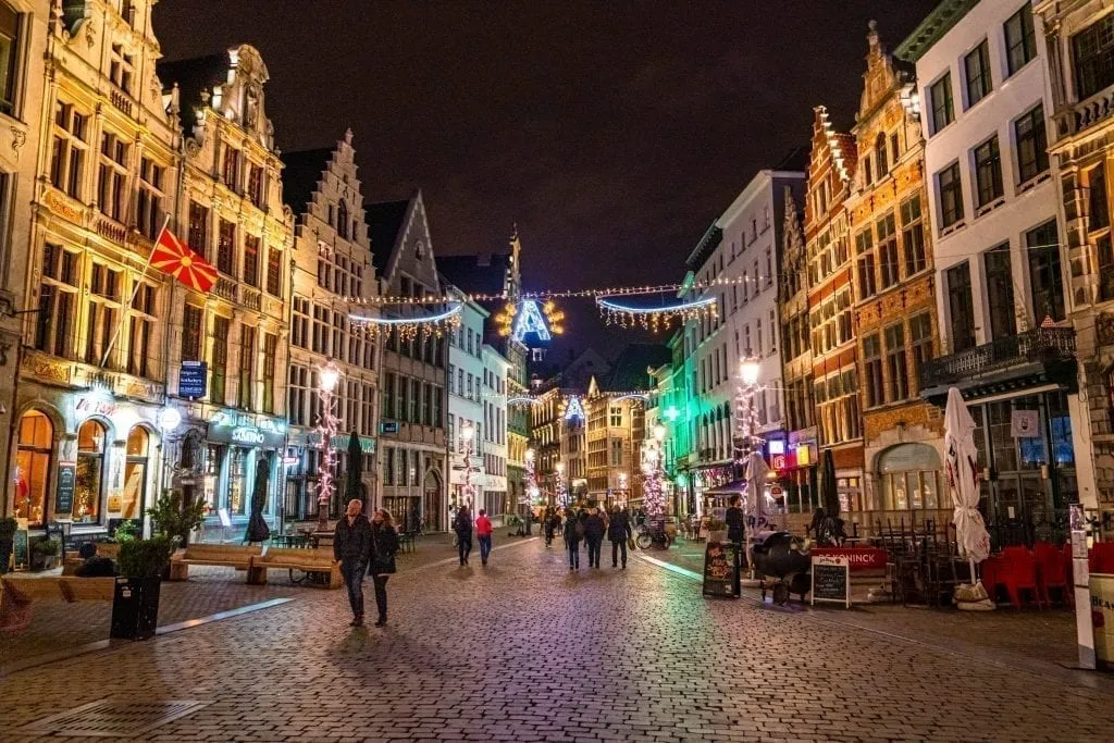 travelers exploring the decorated streets of antwerp belgium at night decorated with christmas belgium in winter lights