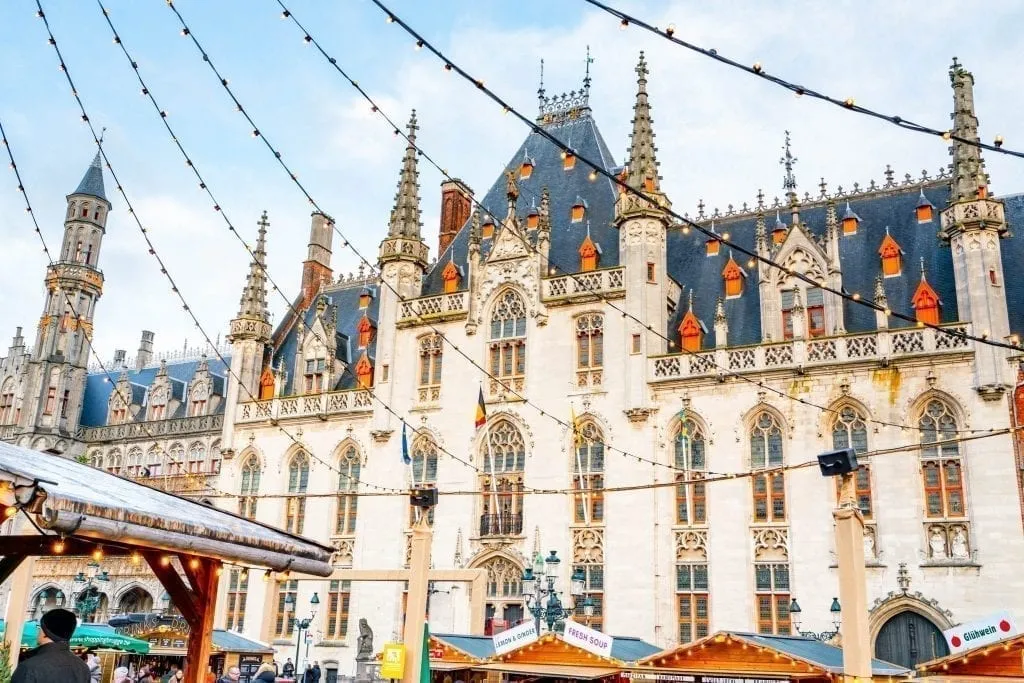 Bruges Markt Building with Christmas lights in the foreground. Don't miss exploring the markt as part of your one day Bruges itinerary