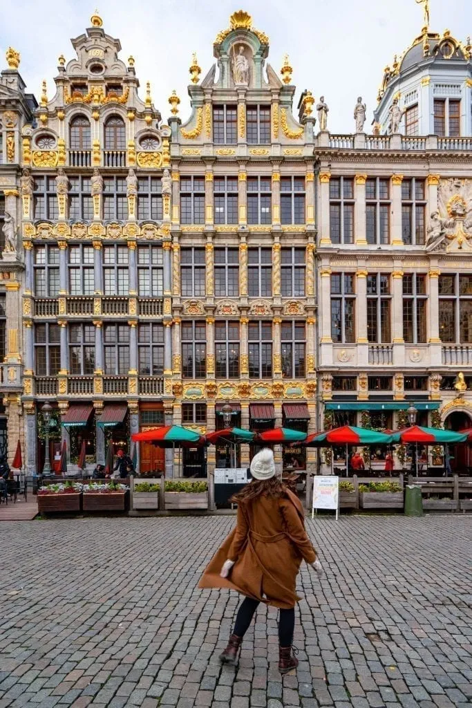 kate storm spinning in a brown coat in grand place belgium