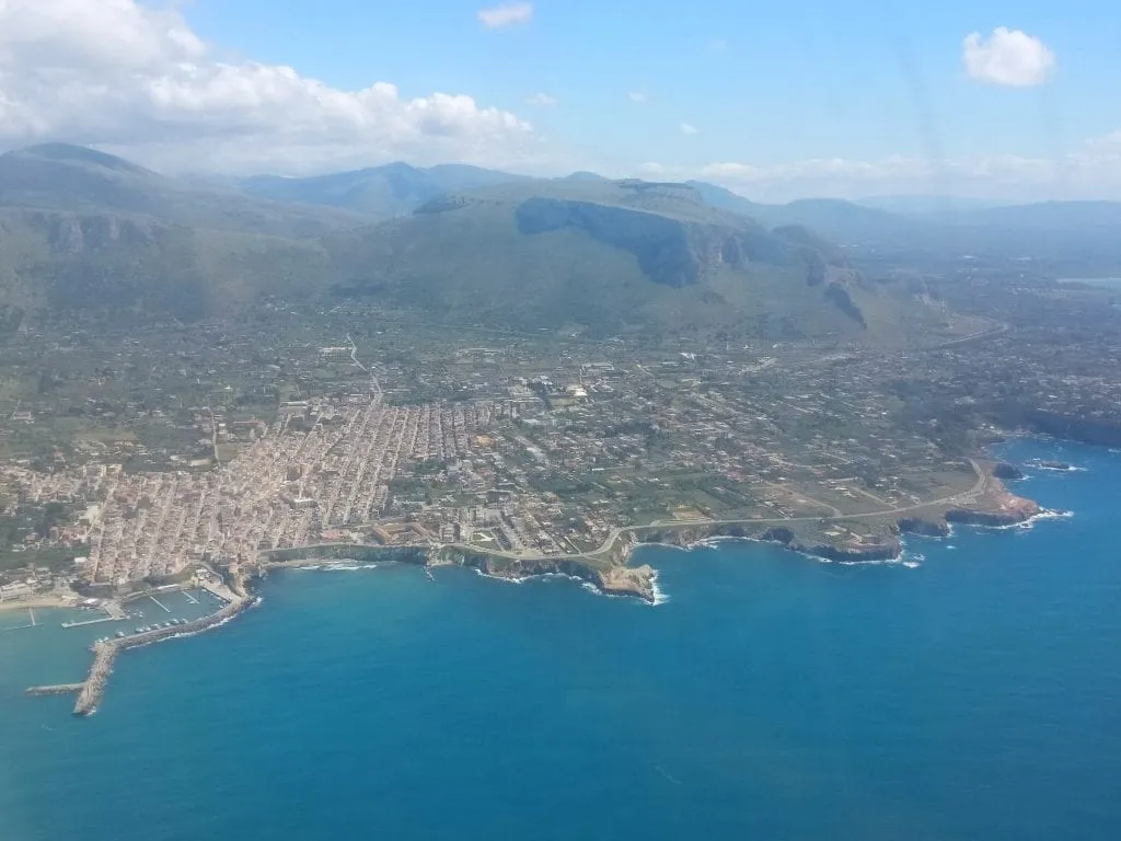 View of Sicily with the Meditteranean Sea in the foreground, taken from a plane window