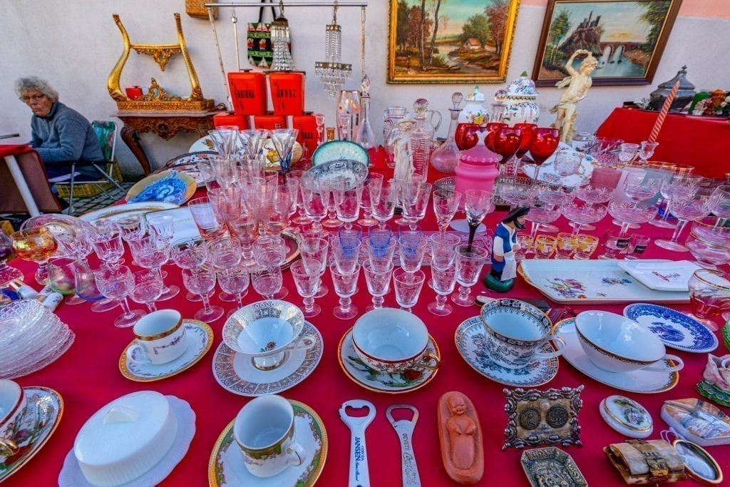 collection of antique dishware for sale when shopping in portugal flea market