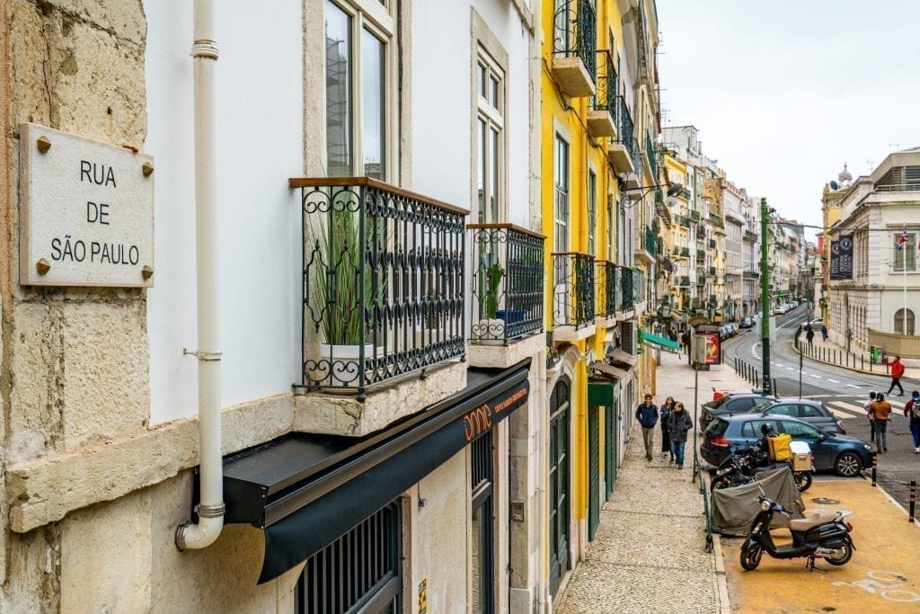 buildings lining a street in lisbon in winter on a cloudy day