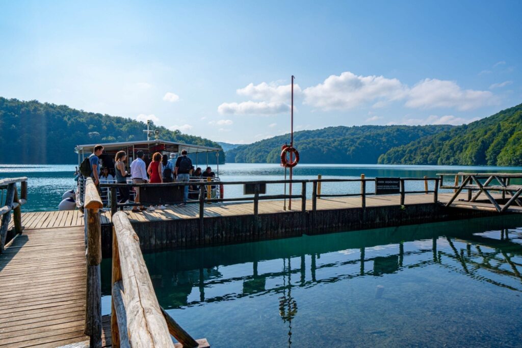 Dock at Lake Kozjak in Plitvice Lakes National Park showing visitors boarding the ferry