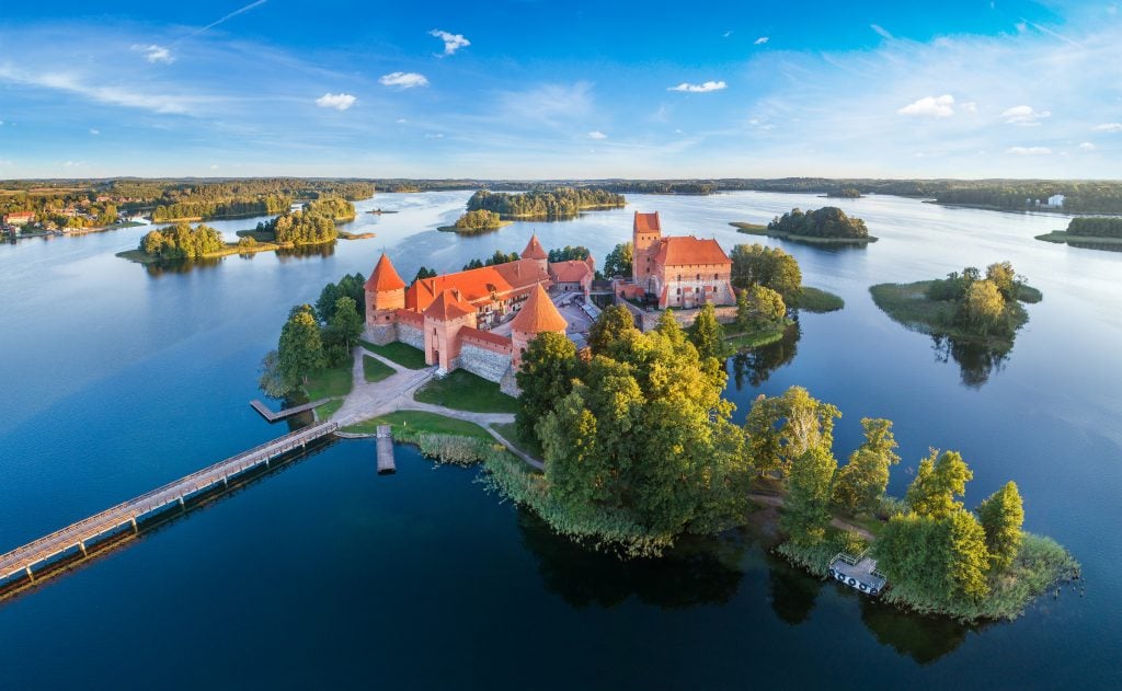 aerial view of trakai castle, a fun stop on a lithuania road trip through europe itinerary