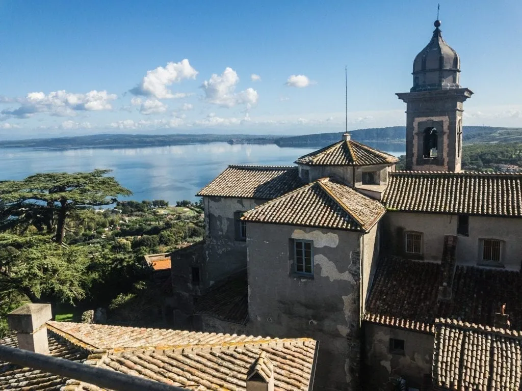 View of Bracciano from the castle with the town in the foreground and lake in the background. Bracciano is one of the best Rome day trips!