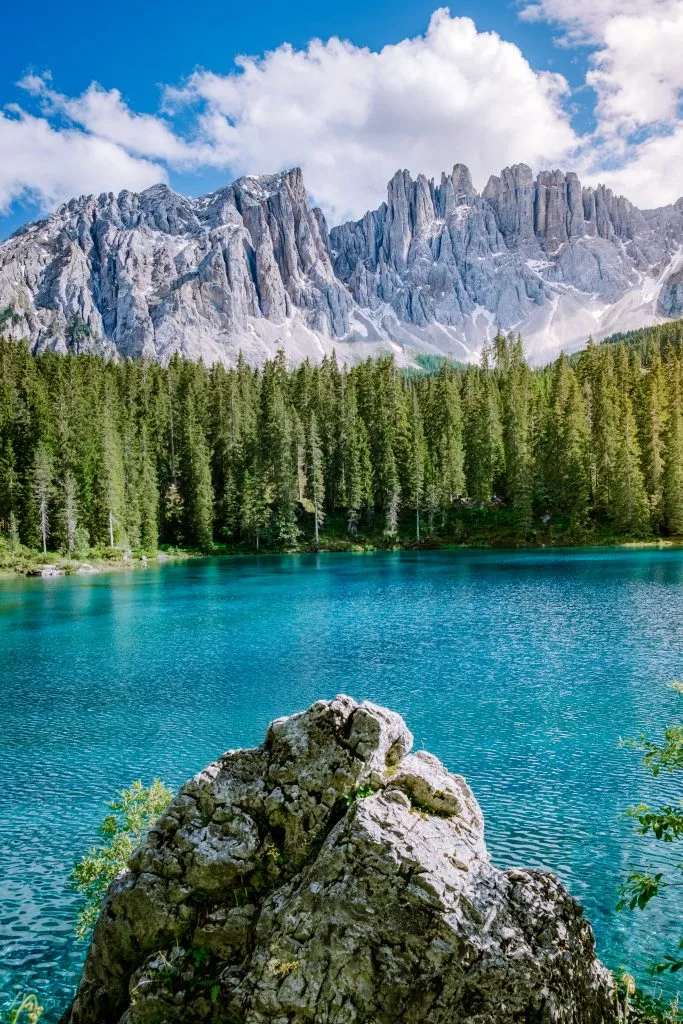 lake carezza italy with dolomites in the background on a sunny day when road tripping northern italy