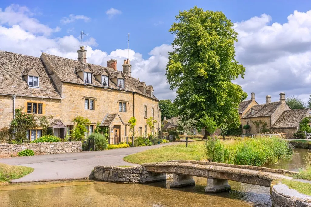 english village of lower slaughter with creek and bridge in the foreground