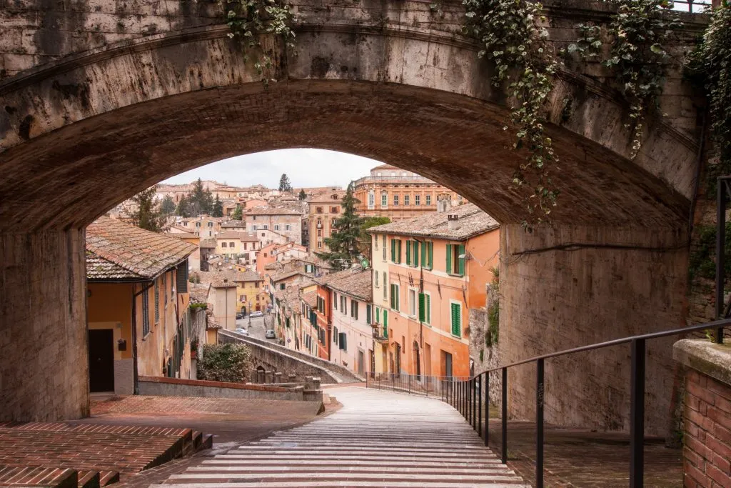 13th century arch framing a stairway leading into perugia italy