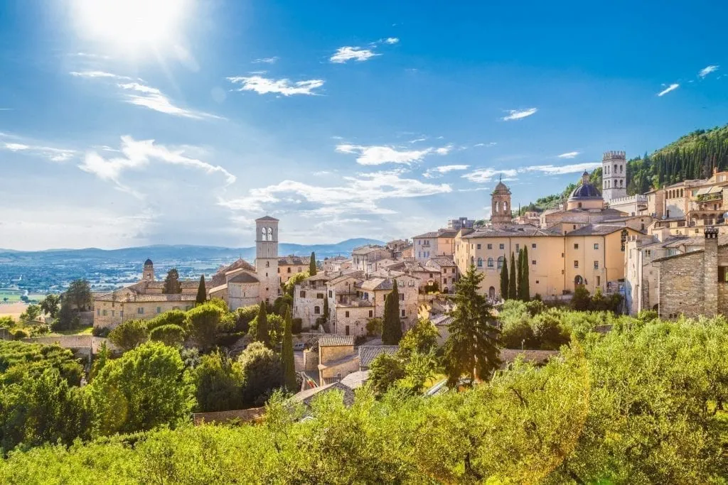 View of Assisi from afar on a sunny day, one of the best day trips from Rome or Florence