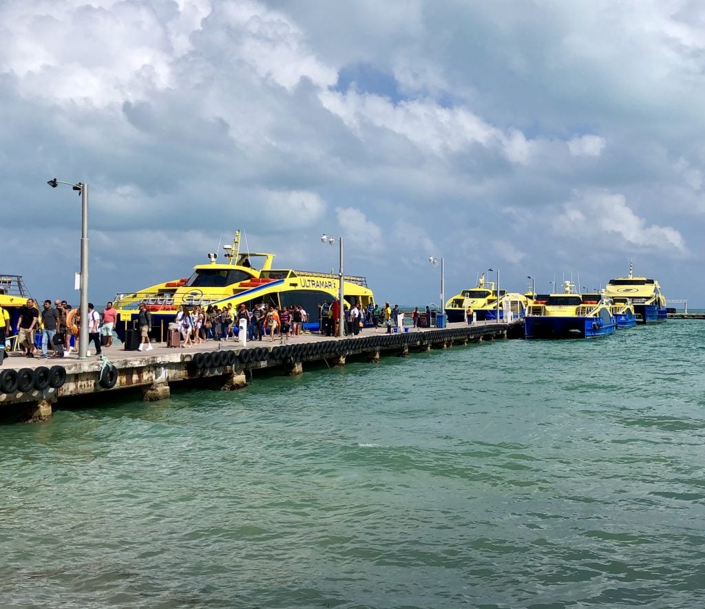 view of people boarding ultramar ferry to isla mujeres mexico on a cloudy day