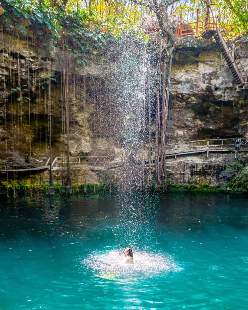 kate storm swimming under the waterfall cenote xcanche mexico
