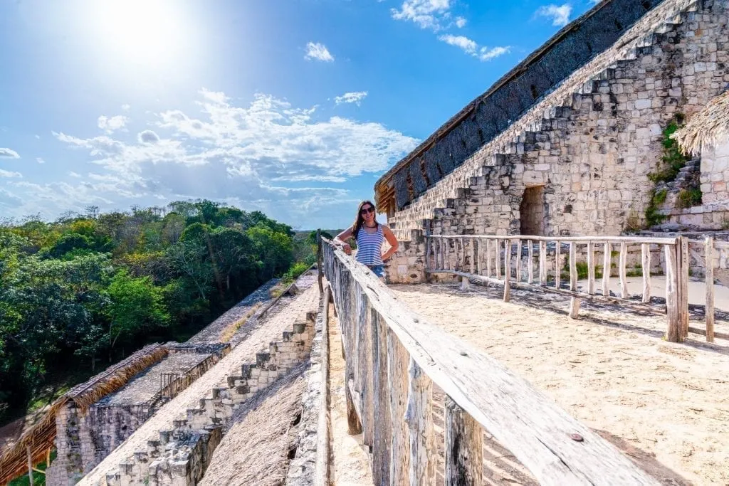 Kate Storm standing on a platform halfway up el torre when visiting ek balam ruins