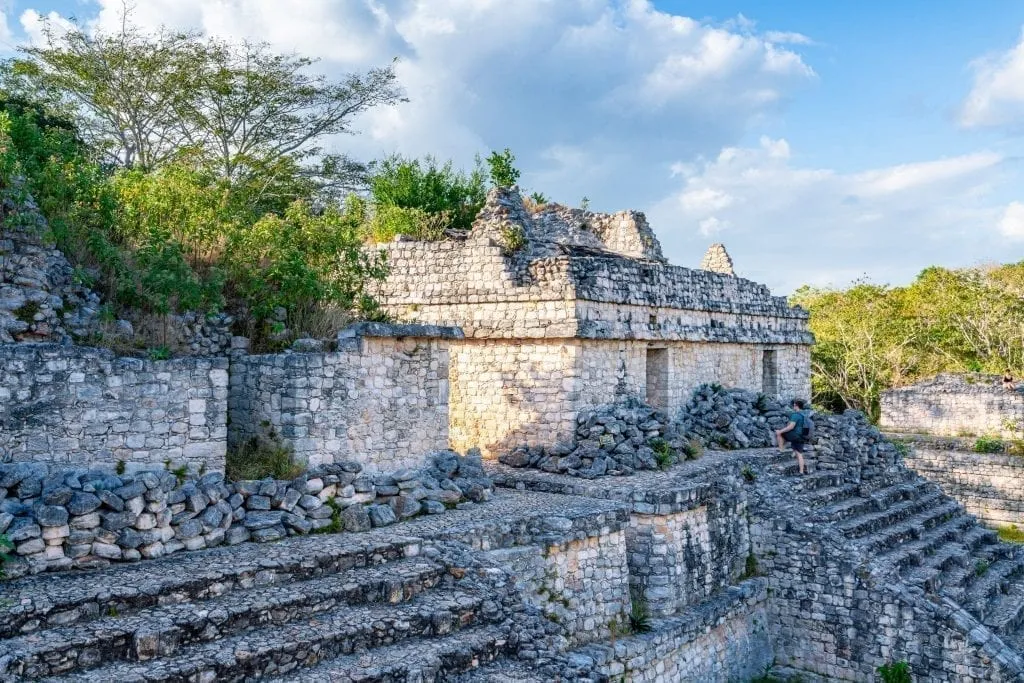 Ek Balam Mexico ruins with staircase on the right and Jeremy Storm climbing it in the distance