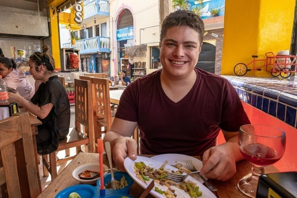 Jeremy Storm eating in an outdoor restaurant in Isla Mujeres Mexico