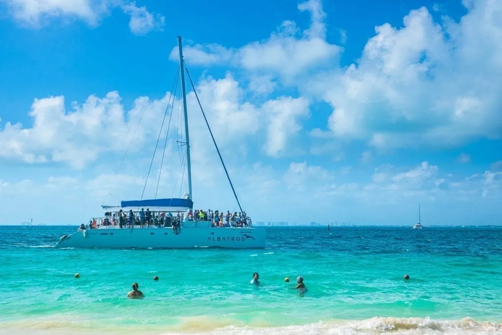 Catamaran full of tour goers offshore near Isla Mujeres Mexico