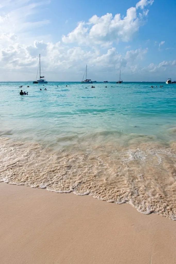 sailboats near a beach in isla mujeres mexico as seen when visiting yucatan peninsula