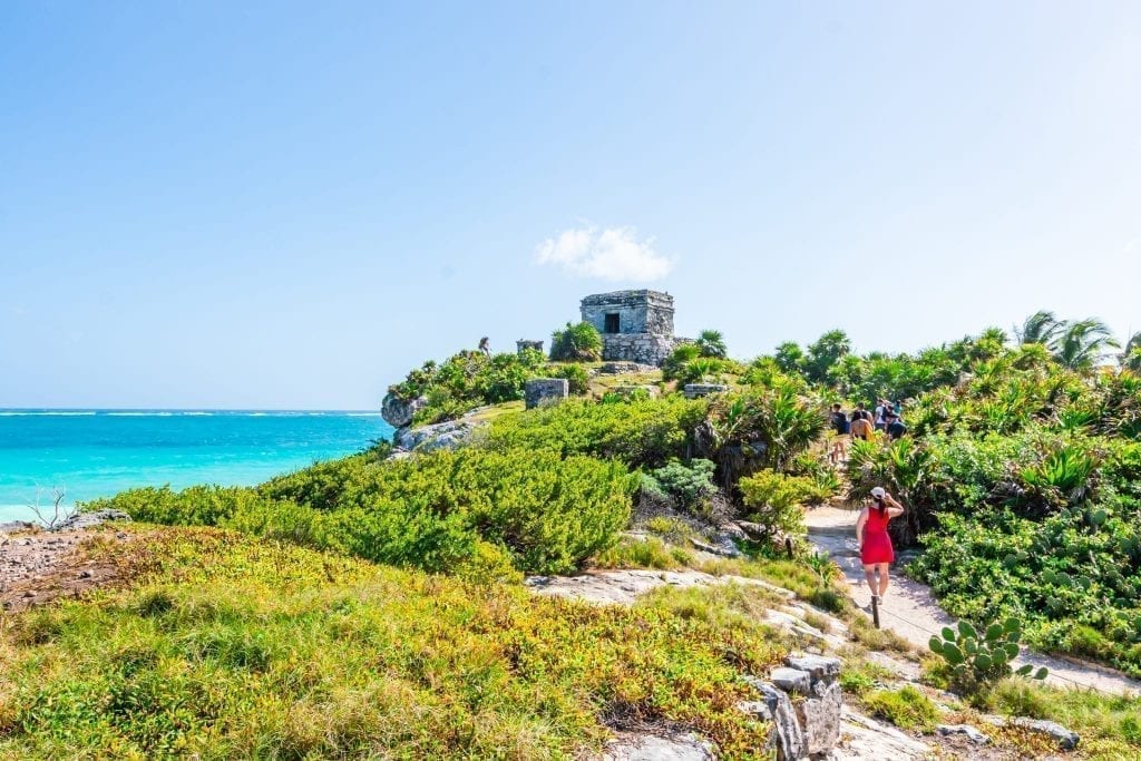 kate storm walking toward tulum mexico ruins