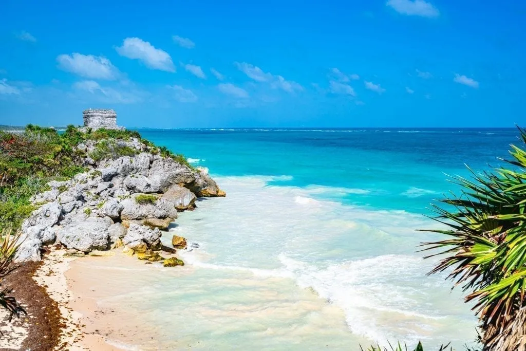 Tulum ruins overlooking a bright beach, as seen as part of a 10 day Yucatan itinerary