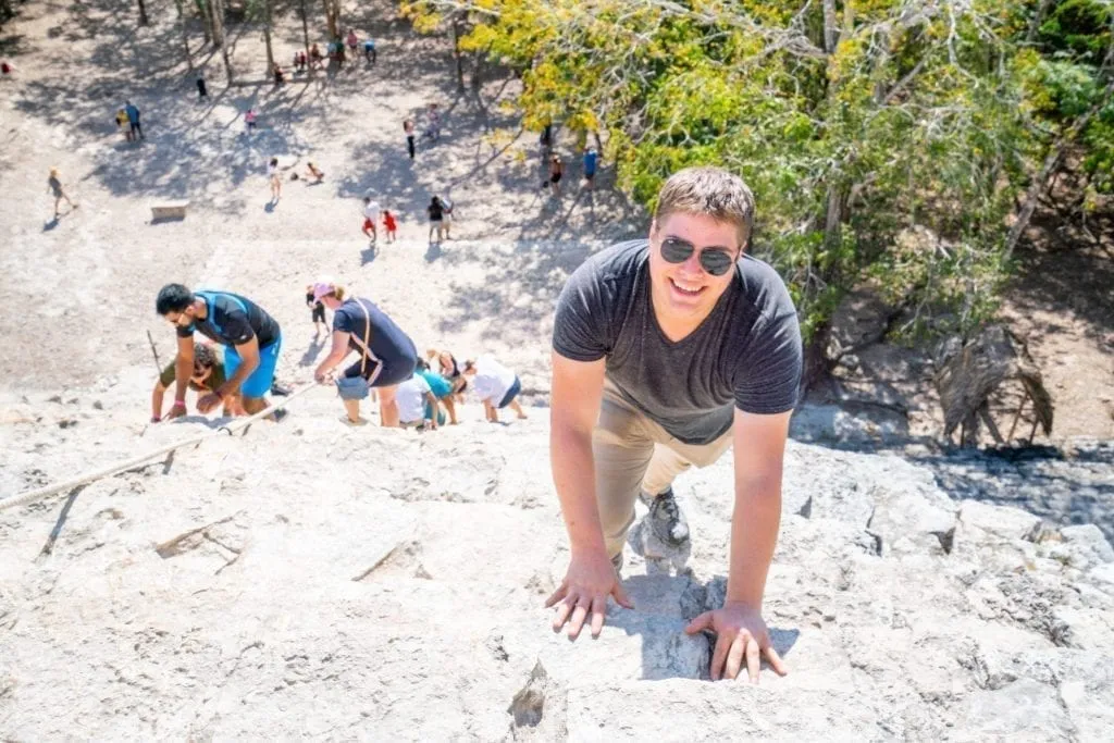 Jeremy Storm climbing Coba ruins pyramind on a road trip Yucatan itinerary