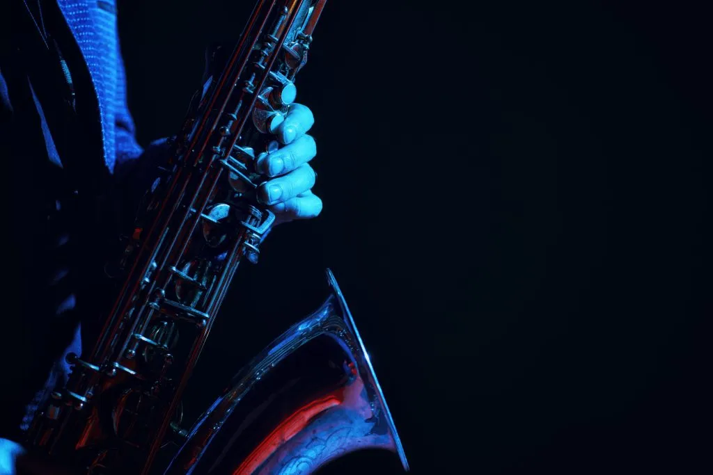 saxophone being played in a dark jazz club