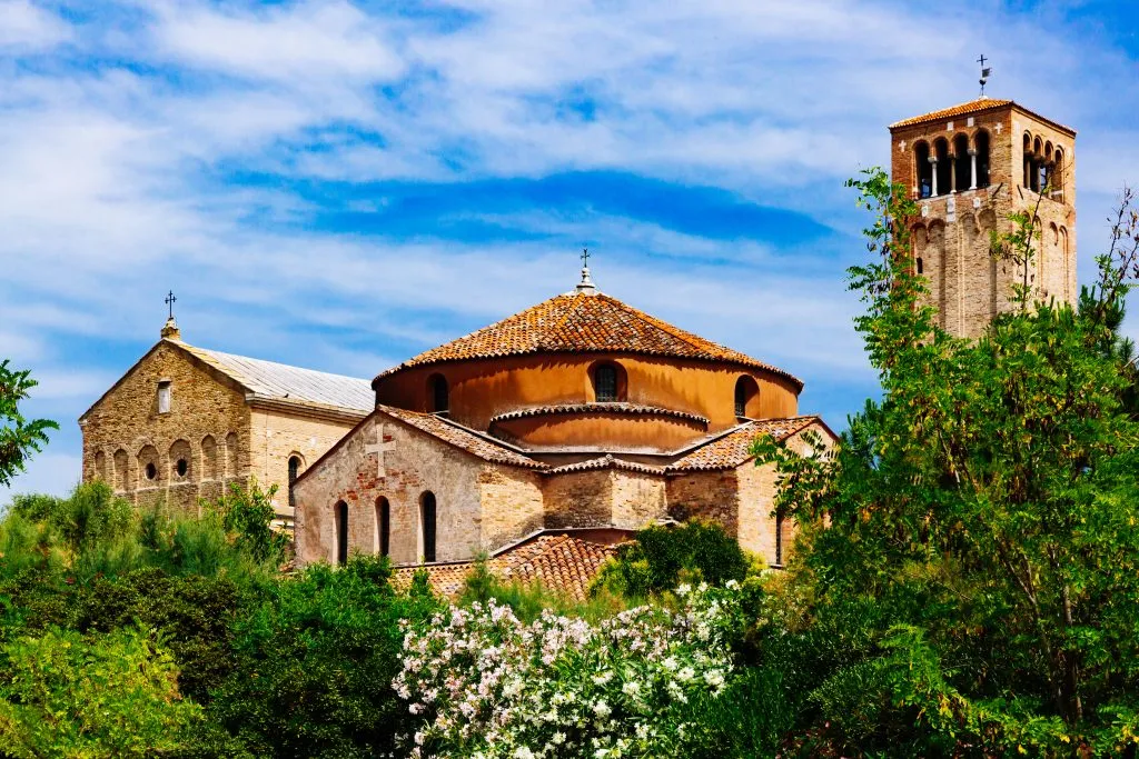 view of exterior of torcello cathedral, one of the best venice hidden gems