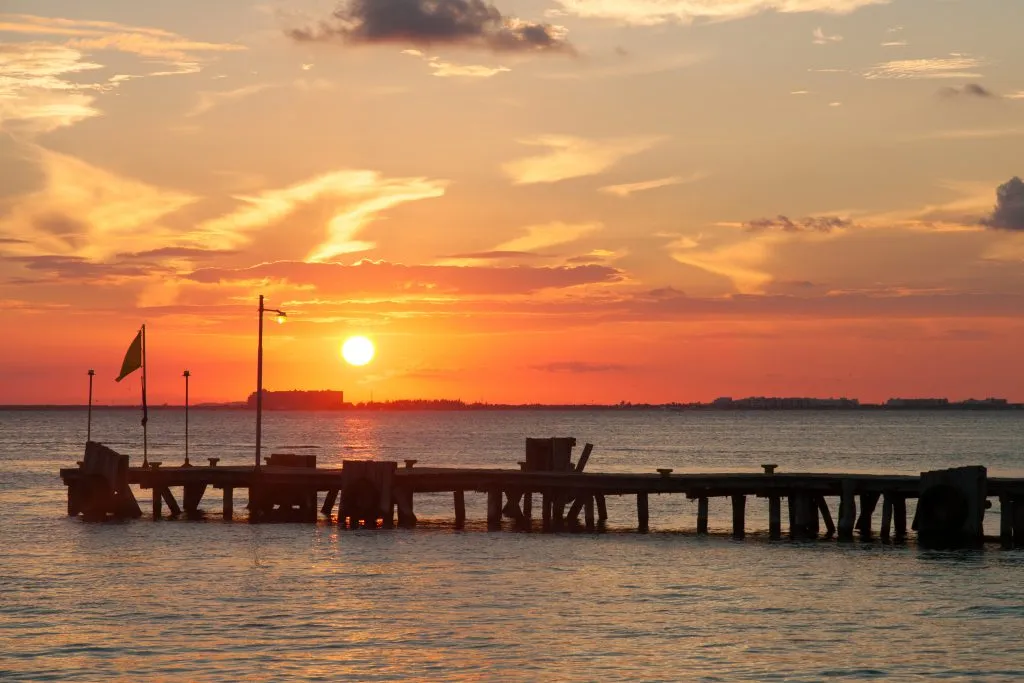 sunset over the water as seen from isla mujeres mexico