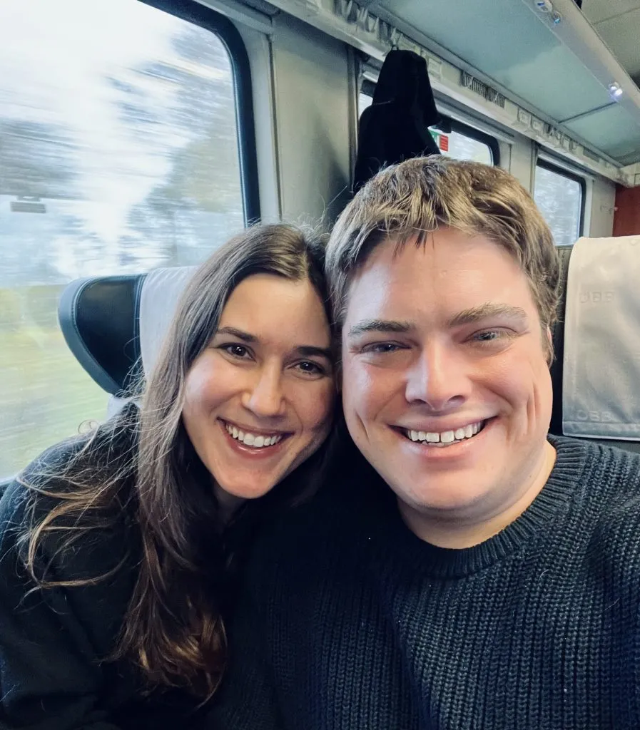 kate storm and jeremy storm taking a selfie on a train across europe