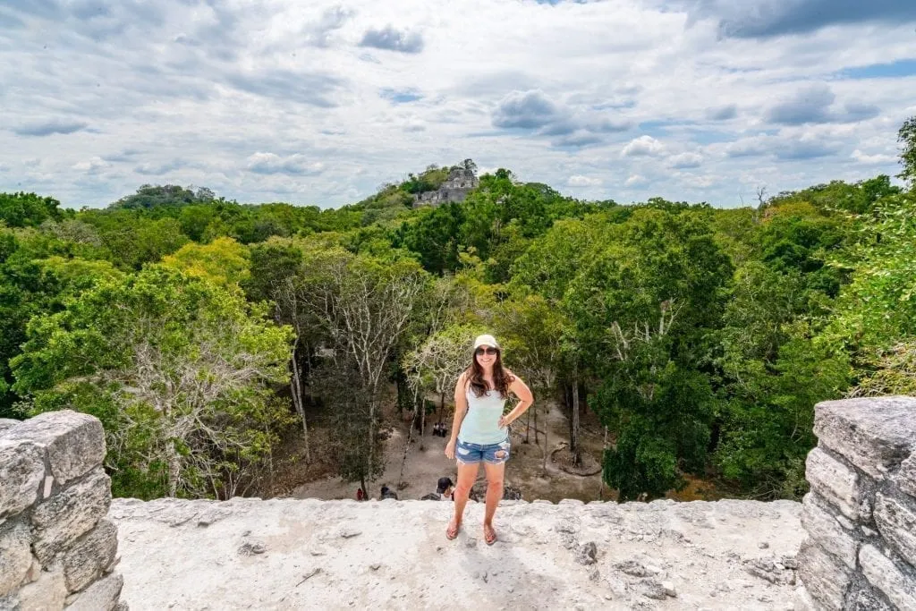 Kate Storm standing on top of one of the Calakmul ruins in Mexico, as seen on a Mexico road trip Yucatan itinerary