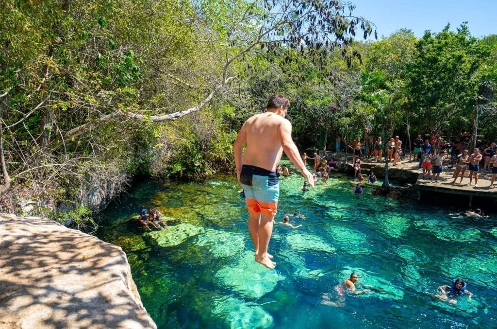 Jeremy Storm jumping into Cenote Azul Playa del Carmen