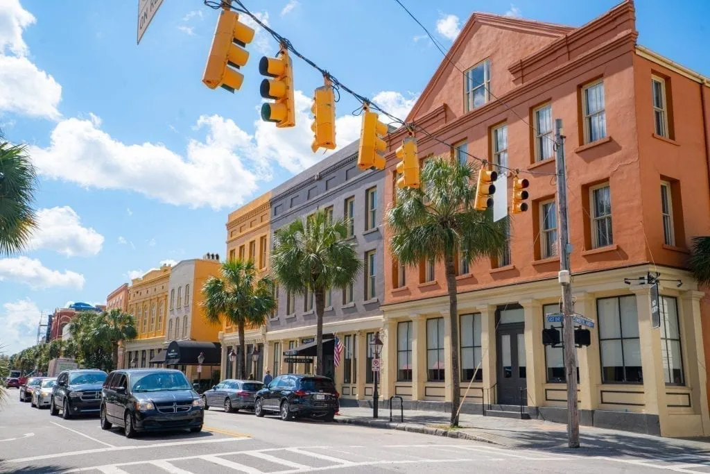 City street as seen during a long weekend in Charleston SC with traffic on the street and street lights in the foreground