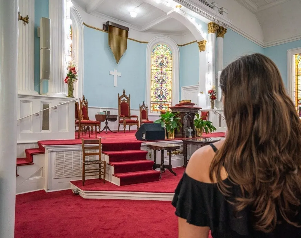 Light blue altar of First African Baptist Church in Savannah GA with a woman's head on the right side of the photo