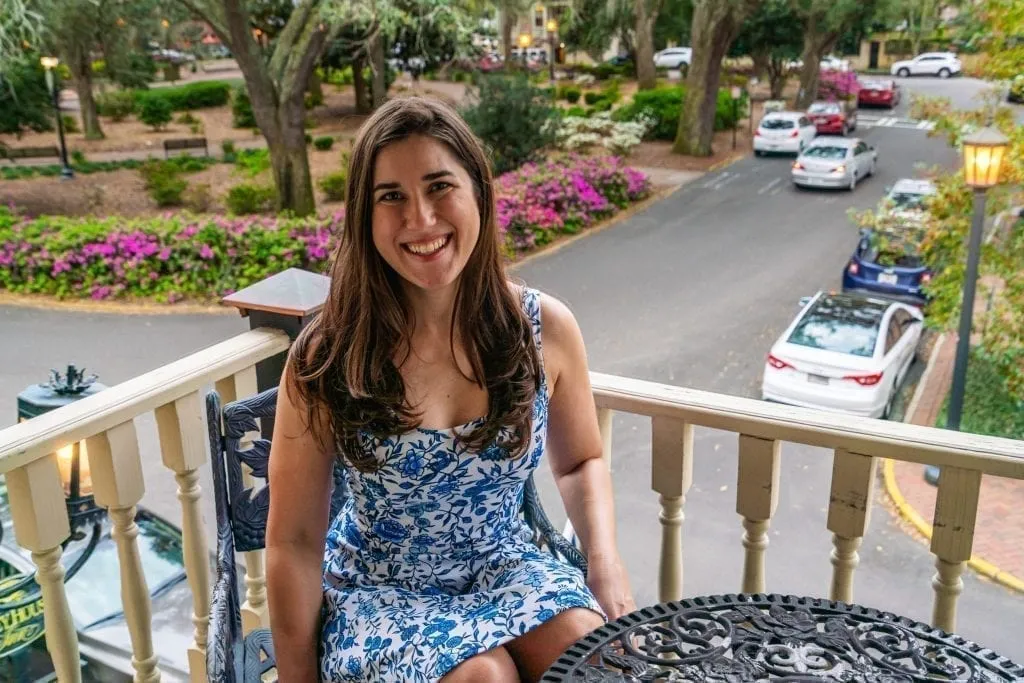 Kate Storm sitting on a balcony overlooking Chippewa Square at Foley House Inn during a long weekend in Savannah GA