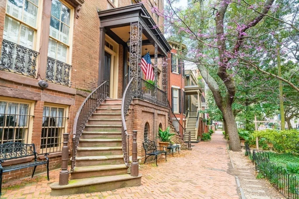 Curved staircase in front of a beautiful home on Jones Street Savannah GA. This street is an essential stop on a long weekend in Savannah travel guide!