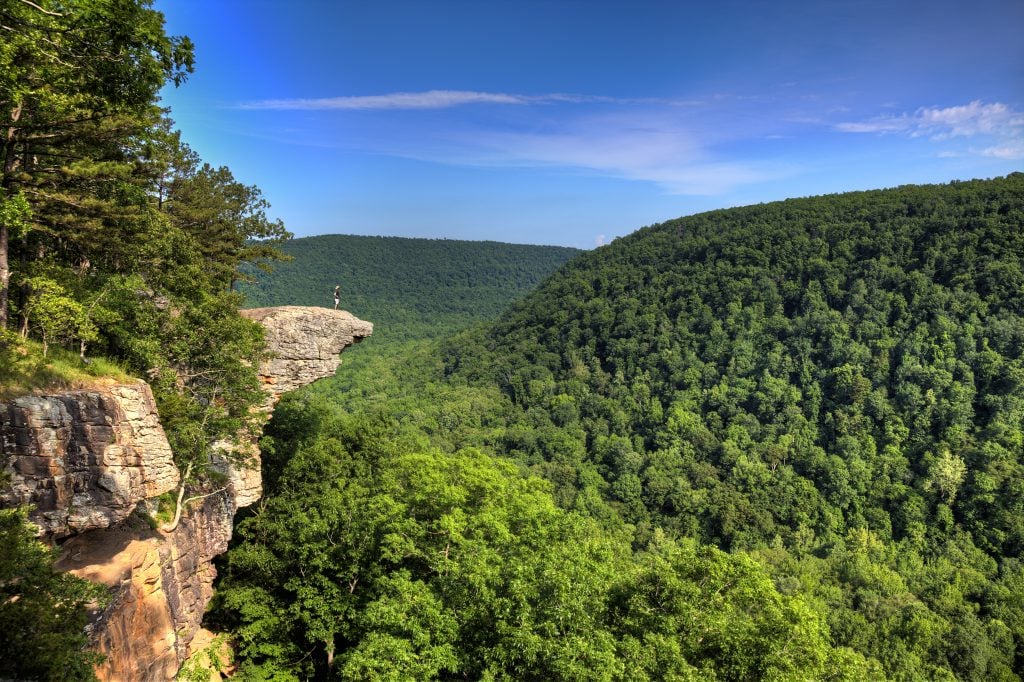 hiker standing on hawksbill crag in northwest arkansas ozark mountains