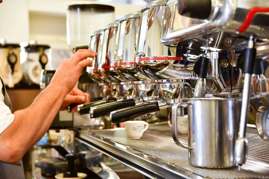 Large espresso machine demonstrating coffee in Italy