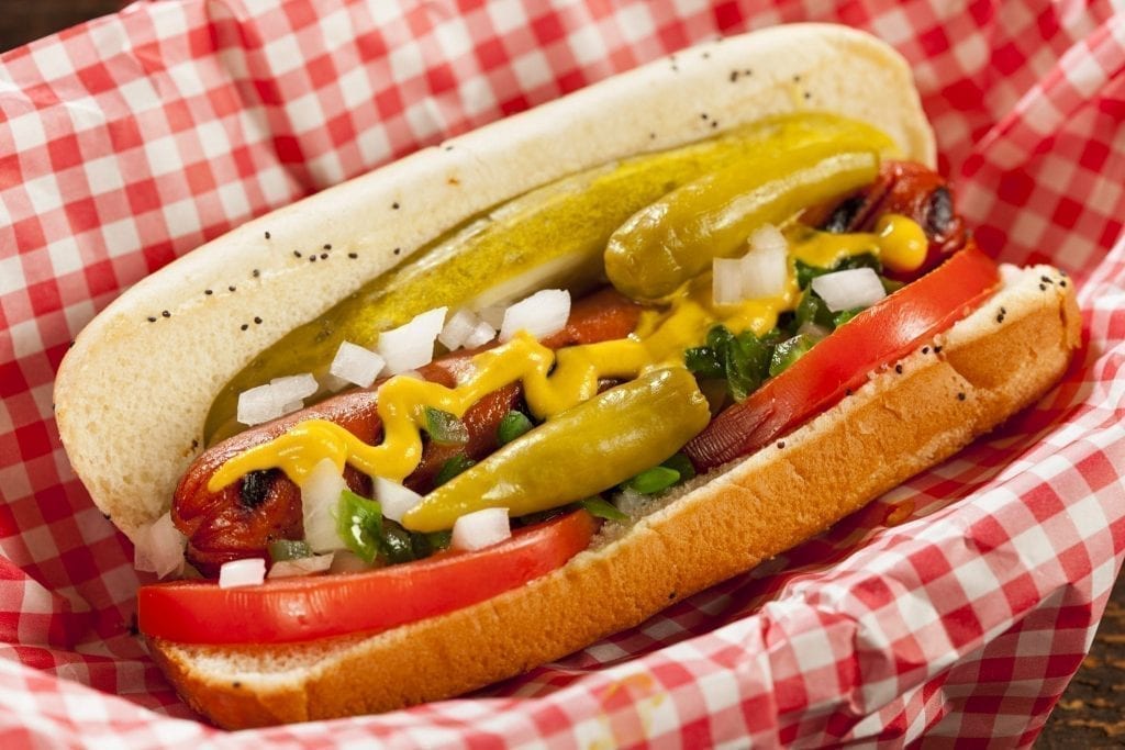 Chicago-style hot dog displayed on a red checkered napkin