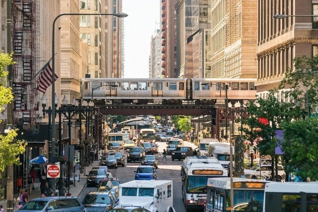 Photo of Chicago train traveling on a bridge over car traffic--using Chicago