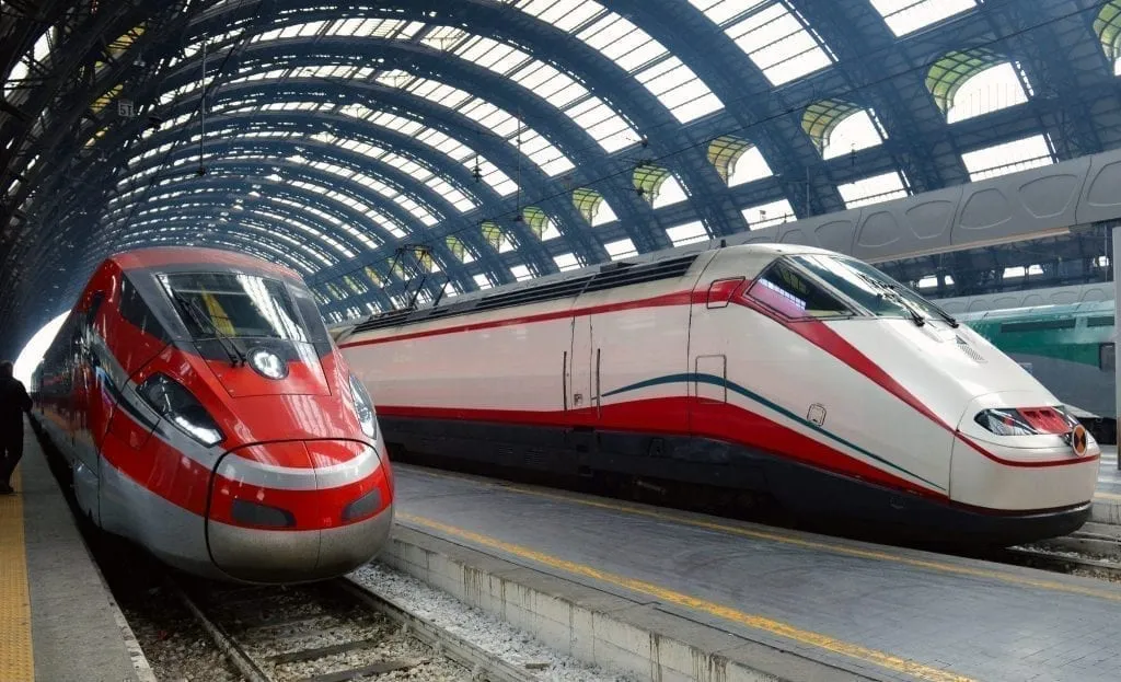 Two trains waiting on an empty platform, a common sight during train travel in Europe and when taking a train through Europe