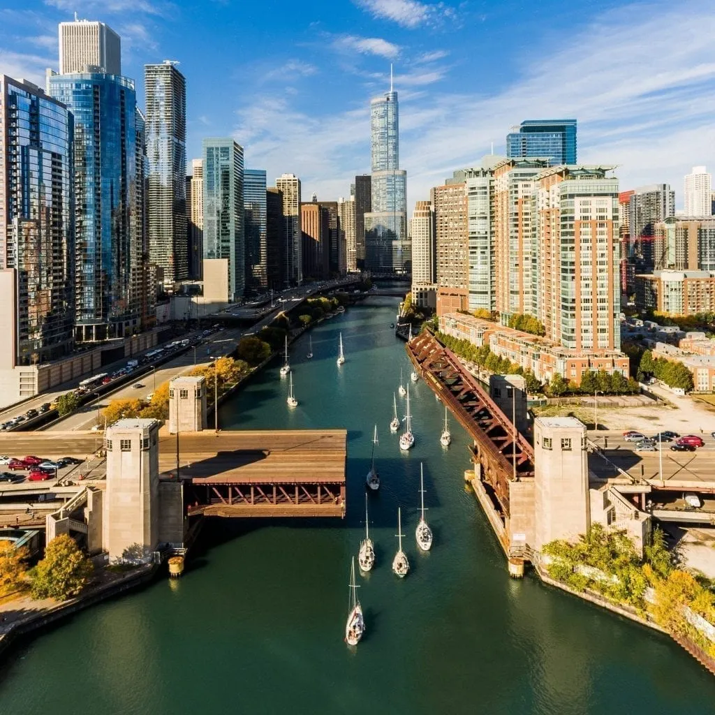 Chicago Skyline with river filled with sailboats in the center, an excellent view to seek out during 3 days in Chicago