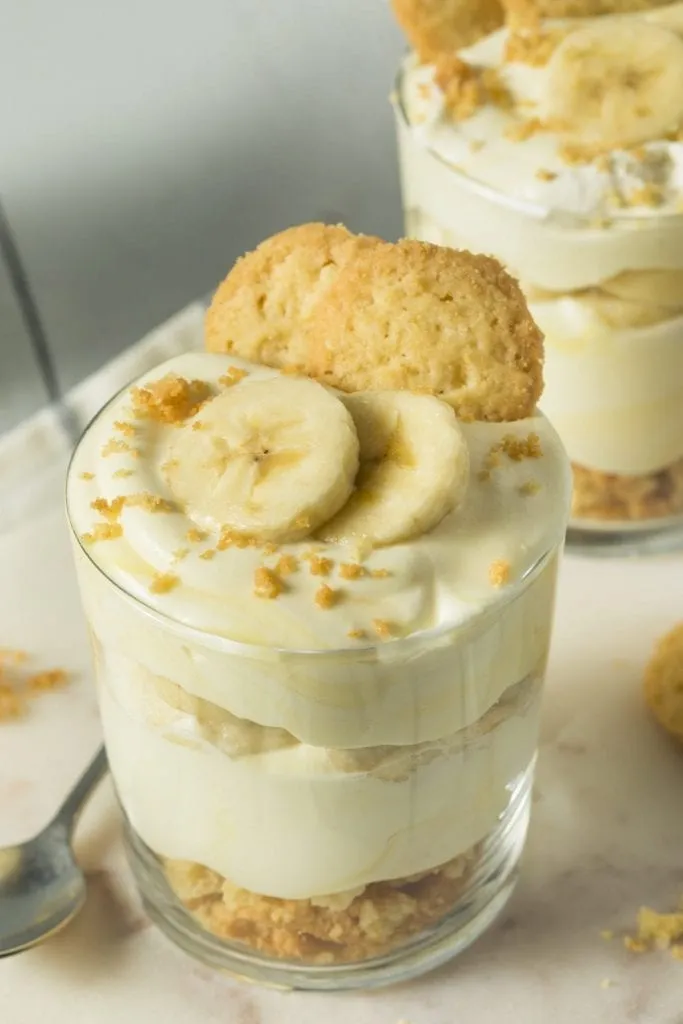 Cup of banana pudding topped with banana slices and a cookie, one of the best desserts in Savannah to eat