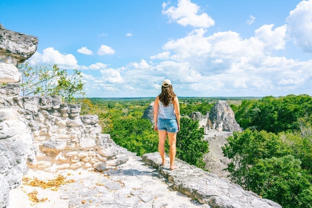 Kate Storm standing on the edge of a Mayan pyramid in Becan Mexico