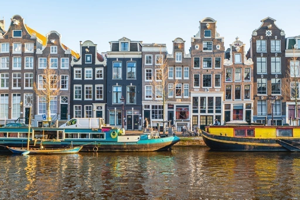 Canal as seen one day in Amsterdam, with houseboats in front of the typical Dutch houses