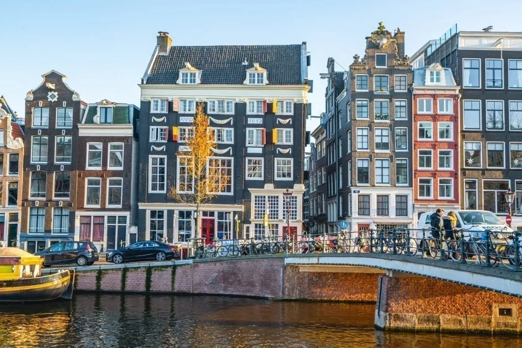 Canal in Amsterdam with a bridge visible to the right of the photo