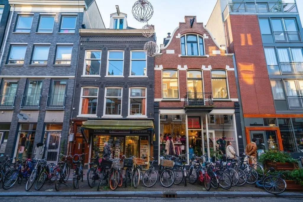 Boutiques in Amsterdam with bikes parked in front of them