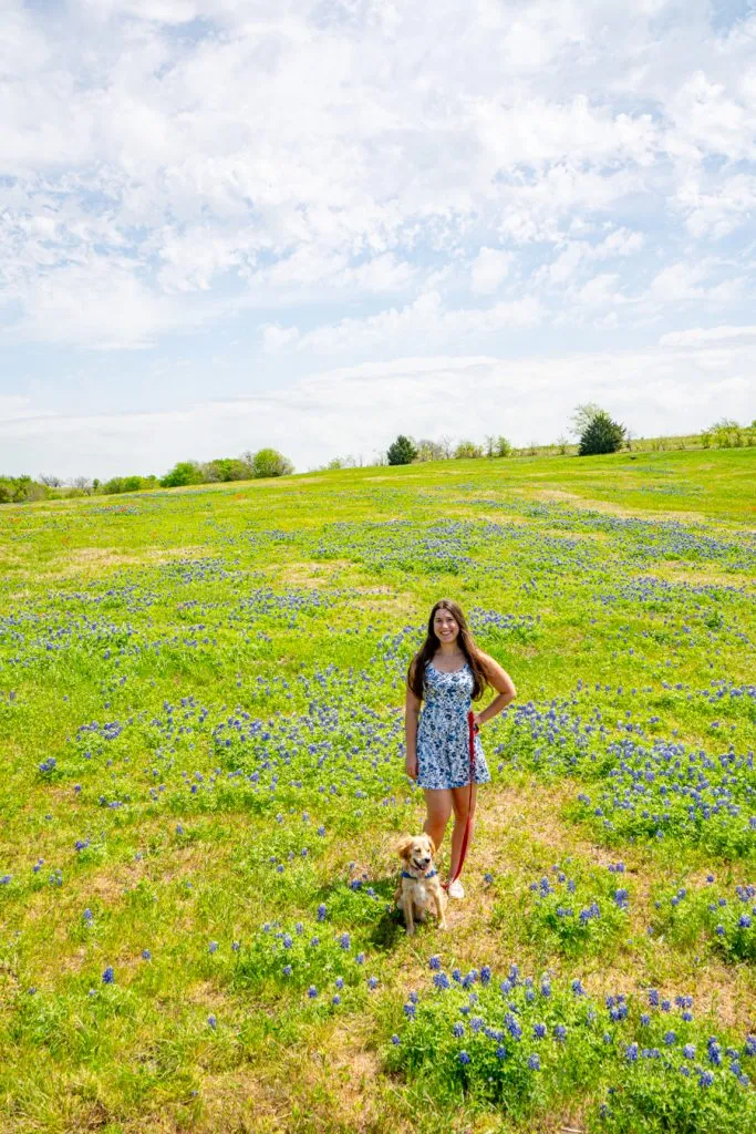 kate storm and ranger storm in a bluebonnet field in ennis, one of the best texas weekend trips